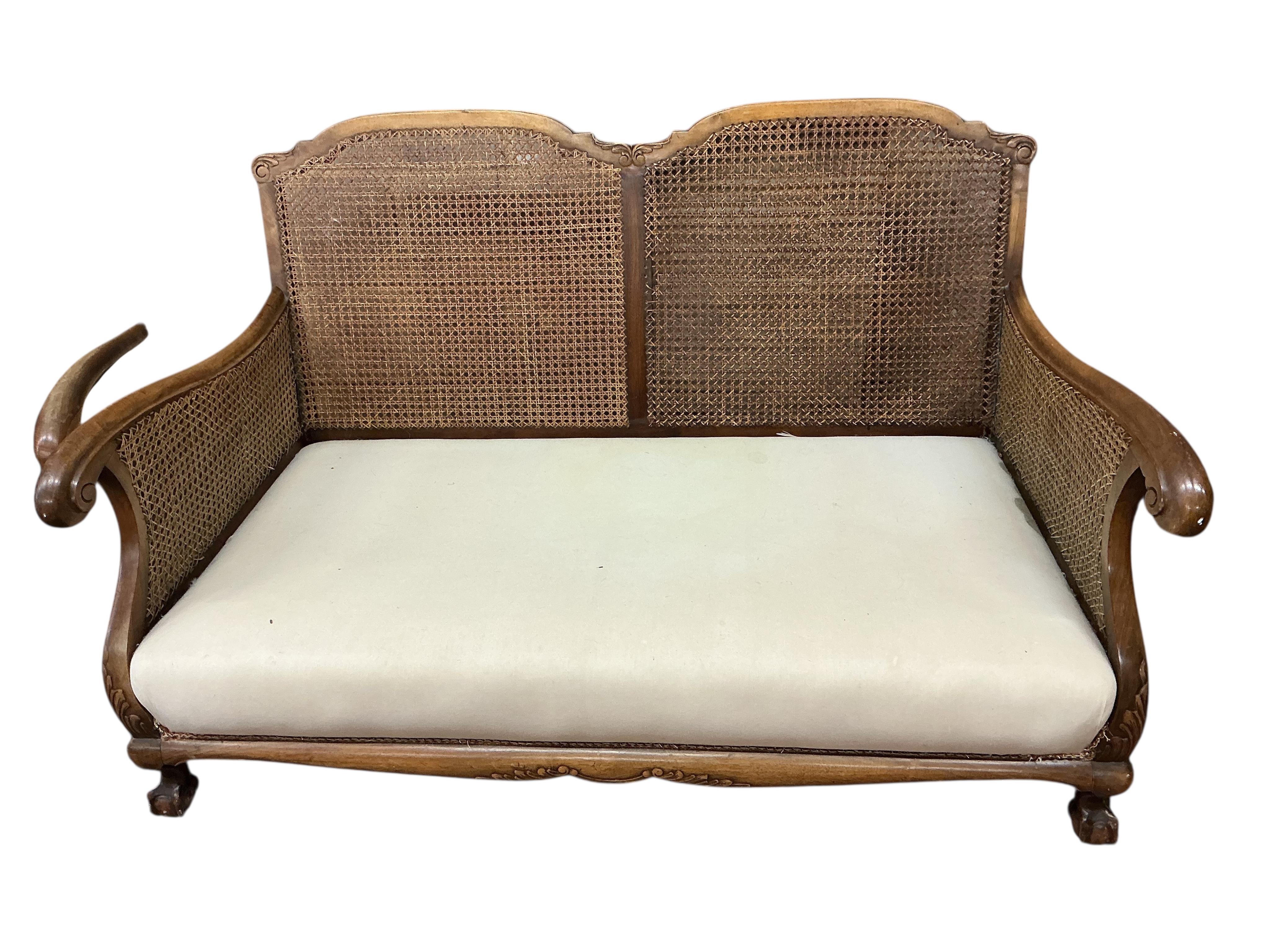 An early 20th century mahogany three piece bergere suite